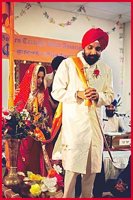 The Bridegroom leads the Bride round the Holy Guru Granth Sahib four times as the 'Laavan' are being sung