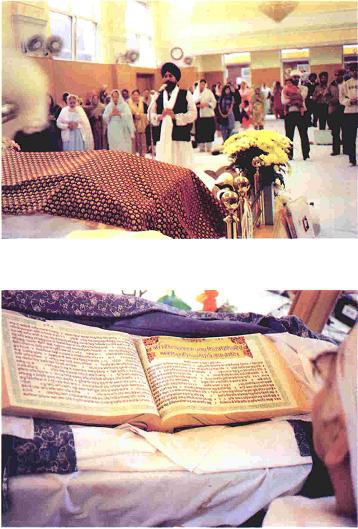 A Sikh priest leading the Ardaas and a reading of the holy Granth after Ardaas